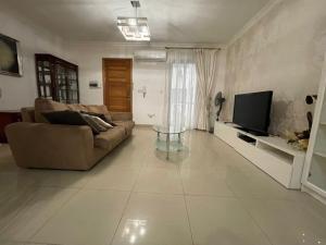 a living room with a couch and a tv at sliema promenade in Sliema