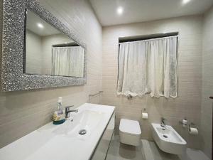 a bathroom with a sink and a toilet and a mirror at sliema promenade in Sliema