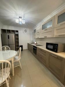 a large kitchen with a table and a microwave at sliema promenade in Sliema +3 photos