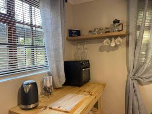 a kitchen with a wooden table and a window at Accommodation at Klein Street-Blue in Paarl