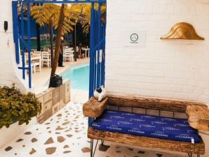 a bench next to a swimming pool with a pool at Little Mykonos in Johannesburg