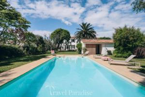 a swimming pool in front of a house at Villa Phoenix in La Couarde-sur-Mer