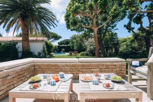 a table with plates of food on a patio at Villa Phoenix in La Couarde-sur-Mer