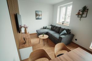 a living room with a couch and a table at Apartmány u Jeníka in Děčín