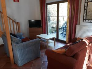 a living room with a couch and chairs and a window at Les Six Vallées in Ramillies