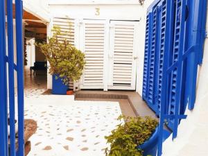 a hallway with blue doors and plants at Little Mykonos in Johannesburg +4 photos