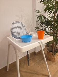 a white table with two bowls on it next to a chair at New! Marbella Apartamento junto a la Playa y Casco Histórico - 2 Habitaciones Dobles - 80 m2 in Marbella +32 photos