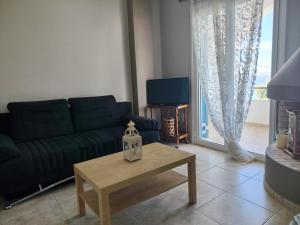 a living room with a couch and a coffee table at Adam s house in Vaia
