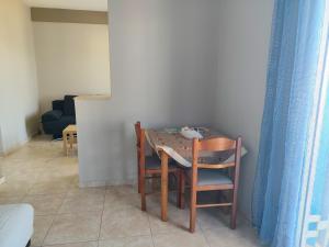 a dining room table with two chairs and a table and chairsktop at Adam s house in Vaia +3 photos