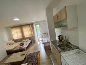 a kitchen with a sink and a bed in a room at Venecia Plaza Struga in Struga