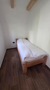a bed in a room with a wooden floor at Mini Garden PREMIUM in Mojkovac