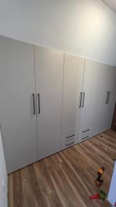 a room with white cabinets in a room at Mini Garden PREMIUM in Mojkovac