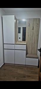 a room with white drawers and a mirror at Mini Garden PREMIUM in Mojkovac +15 photos