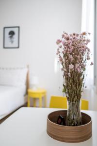 a vase of flowers sitting on a table at Canonica Suites in Bologna