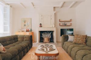 a living room with two couches and a fireplace at Villa Phoenix in La Couarde-sur-Mer