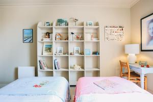 a bedroom with a bed and a desk and a book shelf at Villa Phoenix in La Couarde-sur-Mer +39 photos