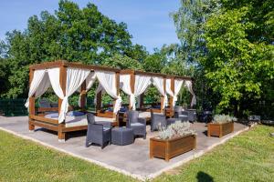 a pavilion with chairs and tables in a park at Kosmajski Izvor in Sopot