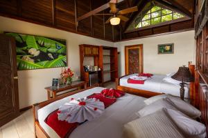 a bedroom with two beds with red bows at Aguila de Osa Rainforest Lodge in Drake +54 photos