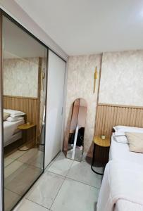 a bedroom with two beds and a mirror at Flat 701 in Guarulhos +16 photos