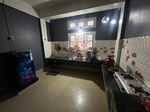 a kitchen with a fish tank in the corner of a room at Pipitsnest 2 homes in Tezpur