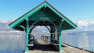 a green shelter on a pier on a lake at Le Lac Bleu - Sevrier in Sévrier +9 photos