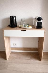 a table with a plate of food and a toaster at Le Lac Bleu - Sevrier in Sévrier