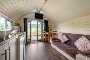 a living room with a couch in a tiny house at 1 Bed in Hereford oc-81293 in Aconbury