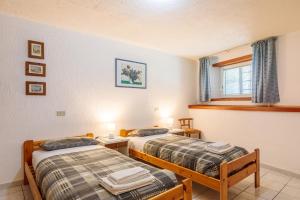a room with two beds and a window at Maison Jaccod_piano terra in Morgex