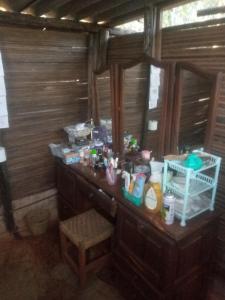 a bathroom with a vanity with a lot of items on it at Weaver's Nest Backpackers Accommodation in Nyanda