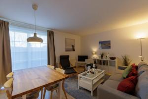 a living room with a couch and a table at Ostseekoje Prerow in Prerow +18 photos