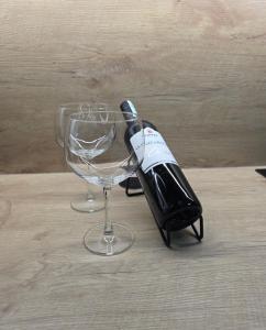 a bottle of wine sitting next to a wine glass at Apartmаn Avram ll in Kotor-Varoš