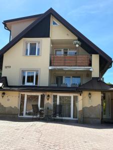 a house with chairs in front of it at Apartmán Olive in Terchová
