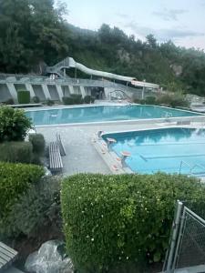 a large blue swimming pool in a yard at Le rocher in Sierre