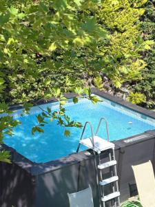 a ladder next to a swimming pool with a ladder at 2K Eco Villa in Plagiárion
