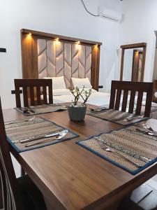 a wooden table with two chairs and a wooden table with at Ruwan's HomeStay in Matale