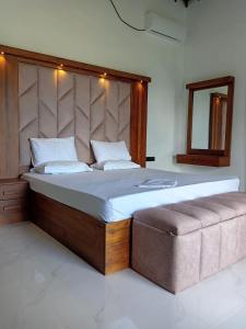 a bedroom with a large bed with a large headboard at Ruwan's HomeStay in Matale