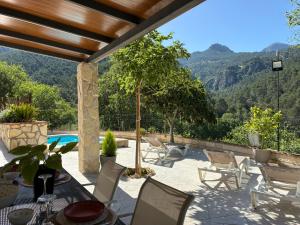 a patio with a table and chairs and a pool at Villa Río Béjar in Quesada