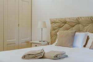 a bedroom with a bed with a towel on it at Il Delfinetto in San Vincenzo +18 photos