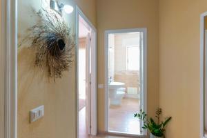 a bathroom with a mirror and a sink and a toilet at Montellinos Suite Tortora in SantʼAntìoco