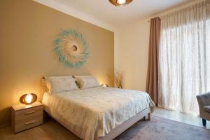 a bedroom with a bed and a large window at Montellinos Suite Tortora in SantʼAntìoco +43 photos