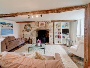 a living room with a couch and a fireplace at 4 Bed in Corfe Castle oc-ic126 in Corfe Castle