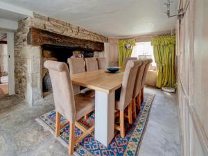 a dining room with a wooden table and chairs at 4 Bed in Corfe Castle oc-ic126 in Corfe Castle