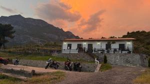 a group of motorcycles parked in front of a house at Xhoen guesthouse in Shkodër