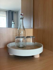 a bottle and two glasses sitting on a table at Double en-suite in Glin