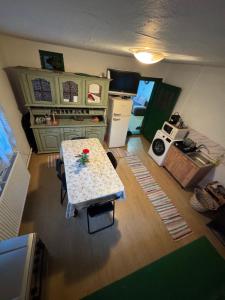 an aerial view of a kitchen with a table and refrigerator at Căsuța din vale in Râșca