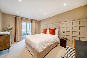 a bedroom with a large bed and a window at Bell House in Amlwch