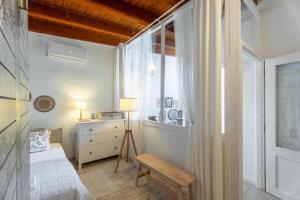 a bedroom with a bed and a dresser and a window at Beachfront House Pythagorion in Pythagoreio