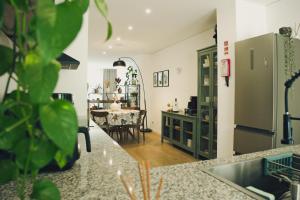 a kitchen and living room with a table in the distance at Slow Living Apúlia in Apúlia +35 photos