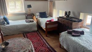a room with three beds and a piano in it at B&B Stare Łysogórki in Stare Łysogórki