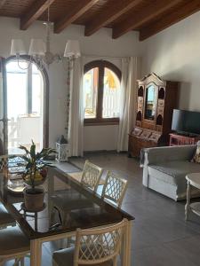 a living room with a table and a couch at Beachfront House Pythagorion in Pythagoreio